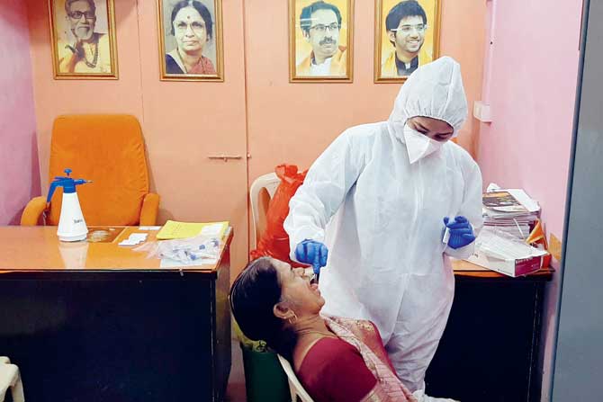 A Kandivli resident gets tested at a camp at a Shiv Sena shakha. PIC/SATEJ SHINDE