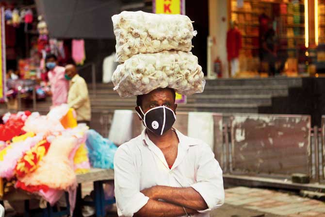 A vendor is seen wearing a mask in Dadar. BMC officials say people have started wearing masks after they started creating awareness about the fine for violating the rule