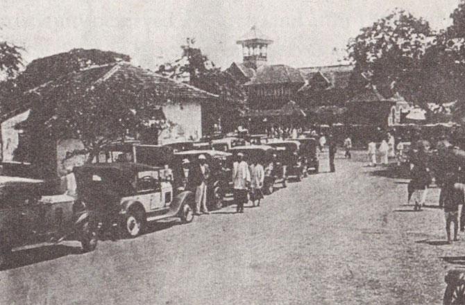 An early 1930s view of Bandra station, Victorian Gothic with wooden eaves, in the week of the fair. Alighting visitors reached the Mount in vintage taxis seen in the foreground. From The Story of Bandra Feast by Olga Valladares