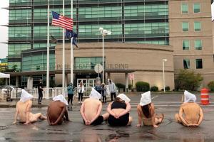 Naked with 'spit hoods' on, protesters decry Prude's death