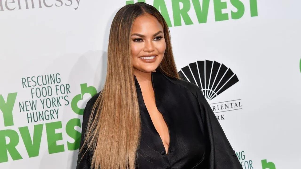 Chrissy Teigen and daughter Luna twin in black bikinis