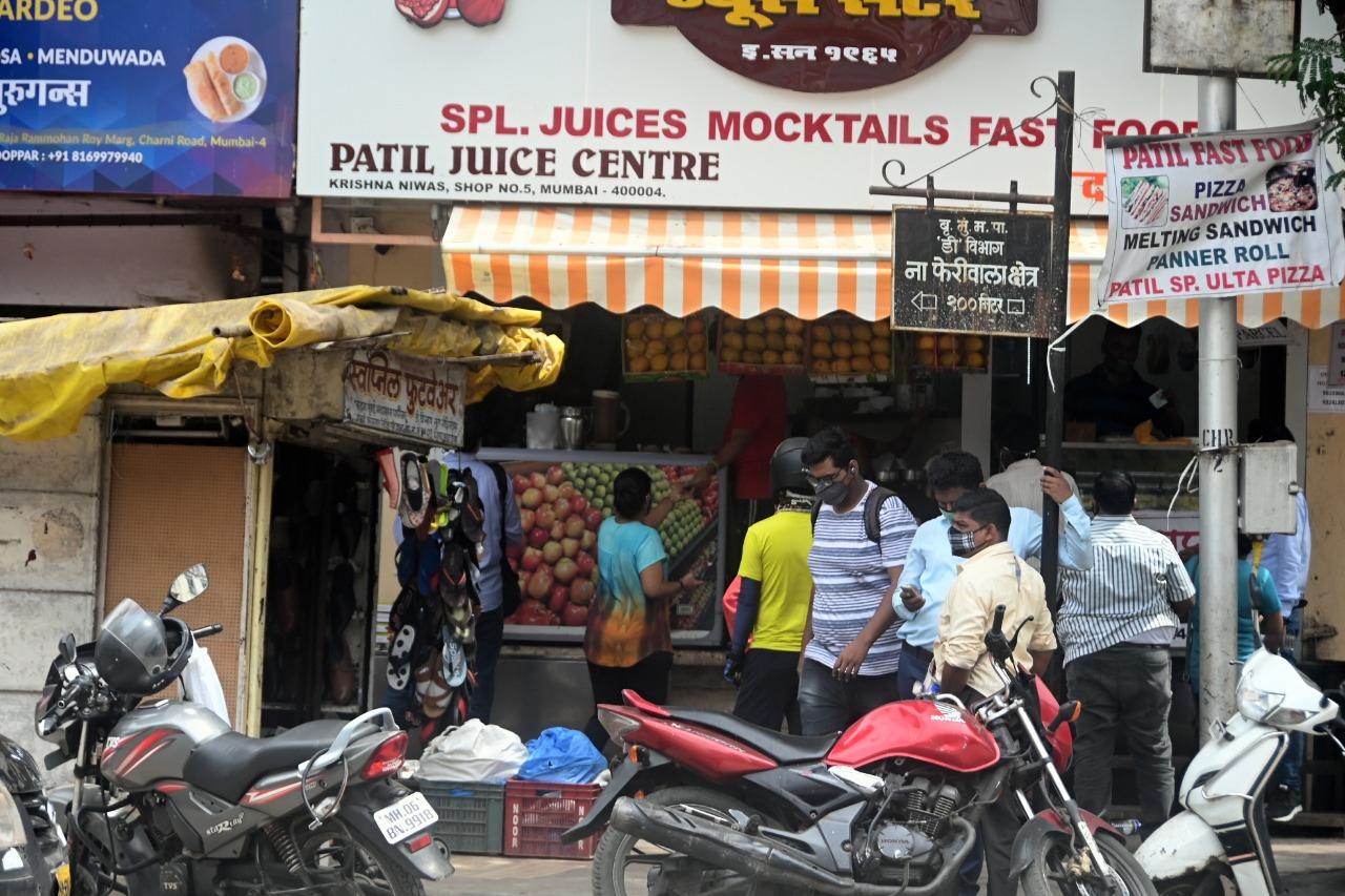 On Thursday, Mumbai reported 7,410 new COVID-19 cases and 75 deaths, the highest one-day fatality count since July last year.  Out of the 75 patients who died in the last 24 hours, six were below the age of 40, the BMC said.
In photo: People beat the summer heat by consuming juice at Charni Road in South Mumbai. Photo: Bipin Kokate