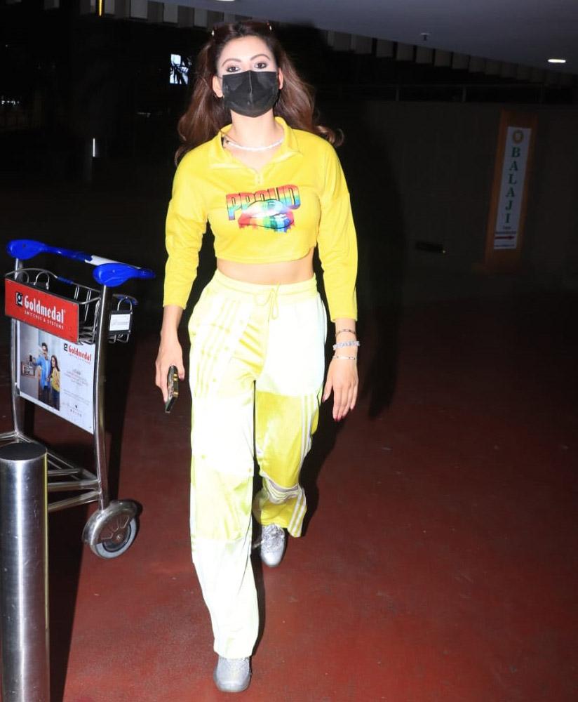Urvashi Rautela sported a bright yellow crop top and same colour track pants. She completed her look with bright silver sneakers.