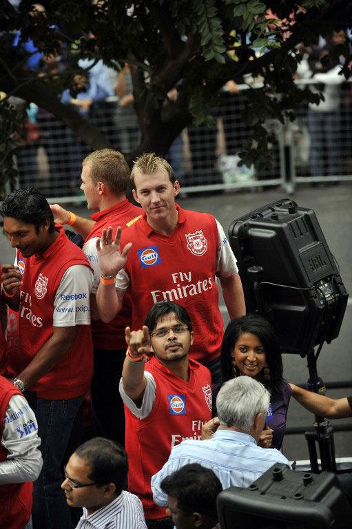  Lee way for fans: Former Australian cricketer Brett Lee and pacer Sreesanth (C) from Kings XI Punjab (then) wave to the crowd as IPL cricket teams parade in the street of Cape Town on open buses on April 16, 2009, one day ahead of the IPL tournament