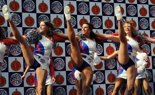 Leg glance!: Cheerleaders for the Royal Challengers Bangalore cricket team of the Indian Premier League (IPL) perform during a preview at the Chinnaswamy stadium in Bangalore on April 13, 2009