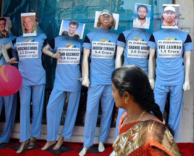 Sold out!:  A woman glances at a display of mannequins bearing images of IPL's Hyderabad team cricketers outside a shop in Hyderabad on February 23, 2008