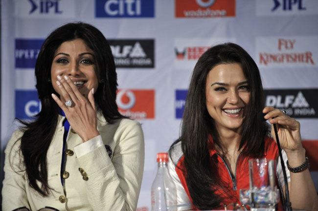 The Preity and Shetty show: Bollywood actresses and co-owners of Punjab Kings and Rajasthan Royals respectively, Preity Zinta (R) and Shilpa Shetty (L) caught in a candid moment at a press conference on April 16, 2009, at the Cape Town international convention center in Cape Town, South Africa.