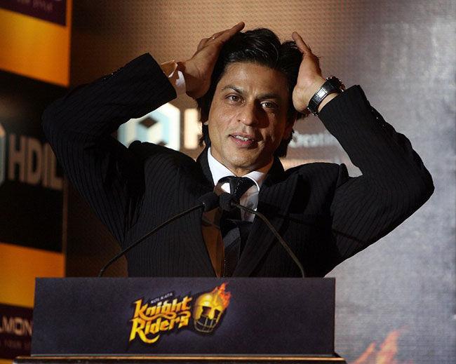 Hair we go, again!: KKR owner Shah Rukh Khan adjusts his hairstyle during a press meet in Kolkata on March 11, 2008