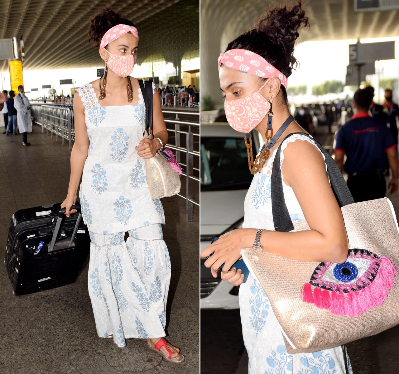 Taapsee Pannu was clicked at Mumbai airport too. The actress opted for a comfy looking cotton sharara suit and a pretty hairband and a matching mask. But what caught our attention was Taapsee's handbag. The bag had embroidered evil eye logo on it, but netizens pointed out that it resembles the logo of Salman Khan's infamous reality show 'Bigg Boss'.