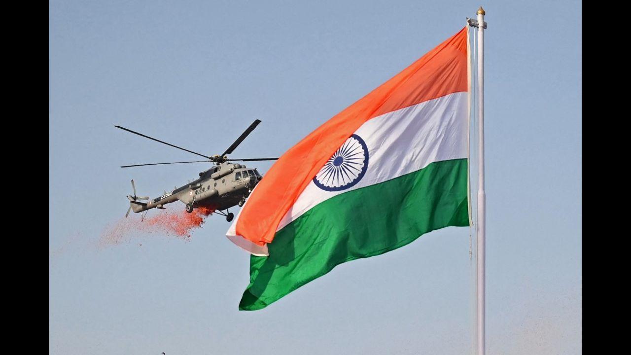 An Indian Air Force (IAF) helicopter flies past the national flag while showering flower petals during the celebrations to mark India’s 75th Independence Day at the Red Fort in New Delhi. Pic/AFP