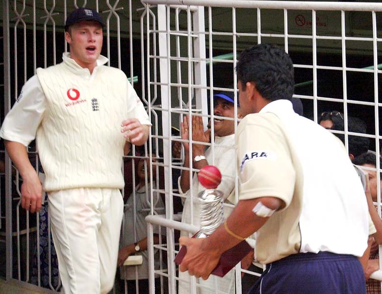 Andrew Flintoff looks on at Anil Kumble after the latter wins a trophy for his performance