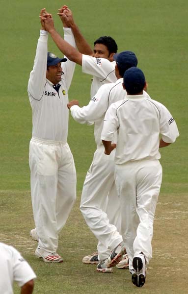 Sachin Tendulkar and Anil Kumble celebrate a wicket during a Test match between India and England
