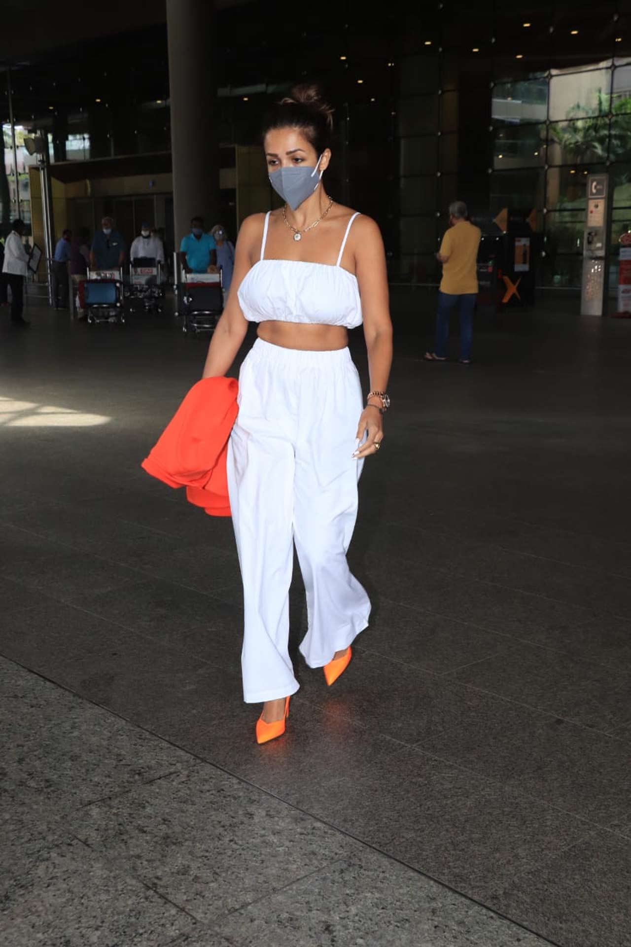 Malaika Arora's white crop top, paired with white pants as her airport look left the fashionistas crazy on social media. Time and again, Malaika and her fashion choices have left everyone in awe of her perfectly picked ensemble.
