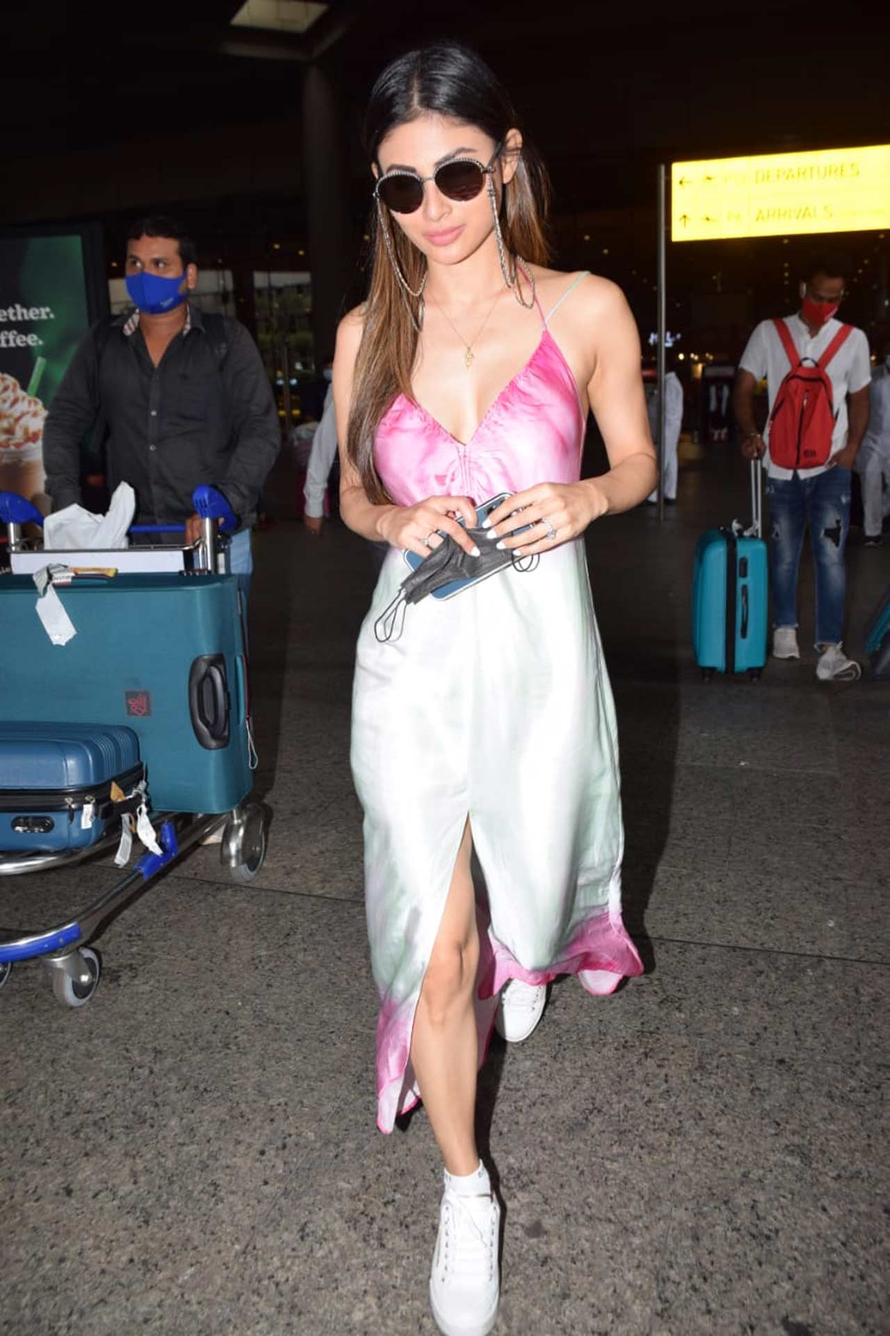 Mouni Roy stunned in a tie-dye satin thigh-high slit maxi dress when clicked at the Mumbai airport. The actress completed her casual look with a pair of white sneakers. On the work front, Mouni will be next seen in Brahmastra, an Ayan Mukerji directorial venture.
