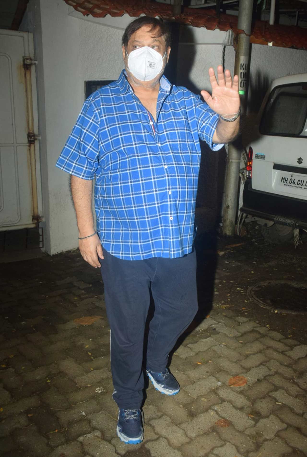 David Dhawan was clicked waving at the paparazzi as he attended the special screening.