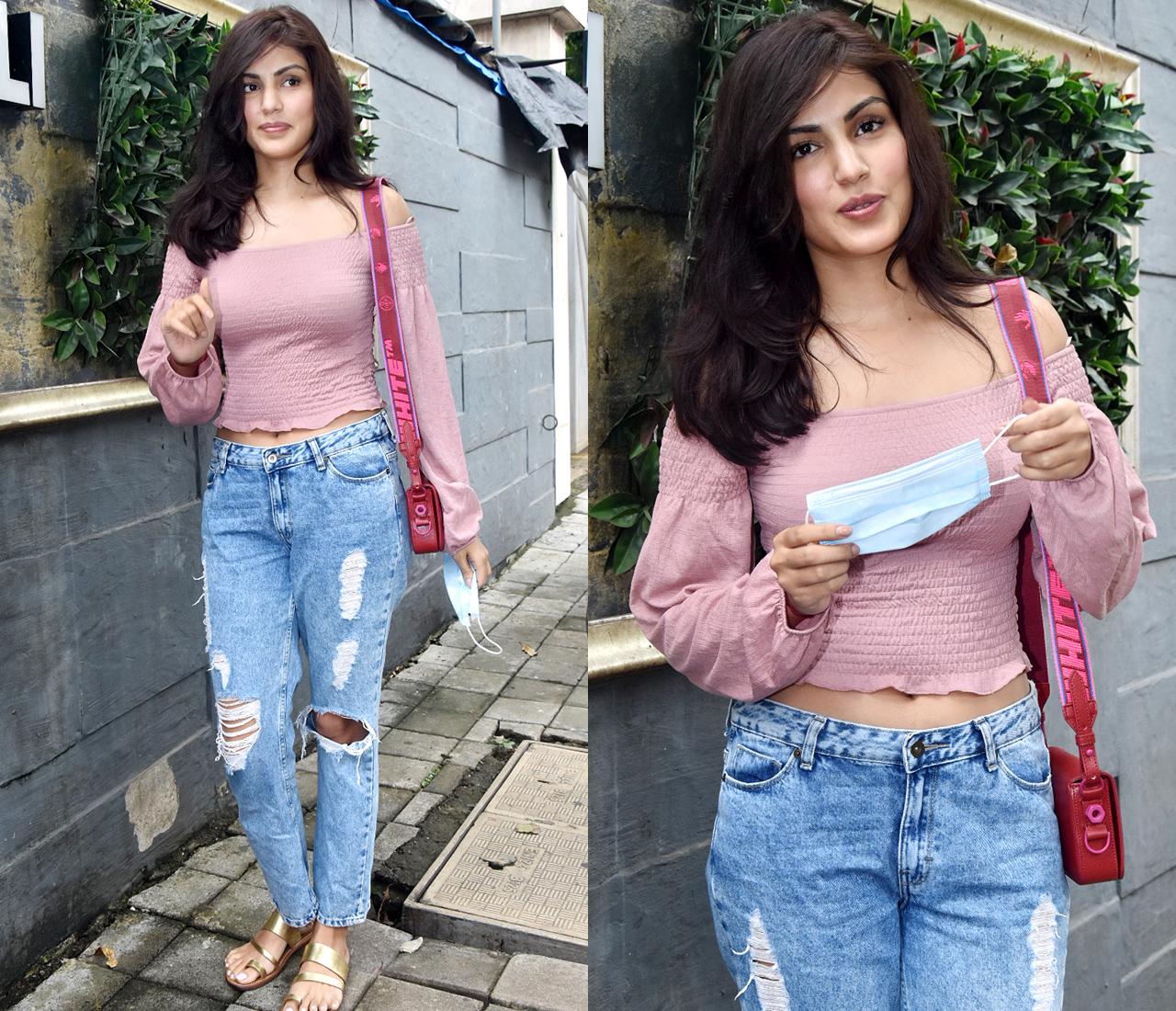 Rhea Chakraborty was photographed outside a salon in Juhu, Mumbai. The actress, who is gearing up for the release of her next film 'Chehre', sported an off-shoulder peach top, paired with blue ripped jeans. Rhea even posed for few pictures.