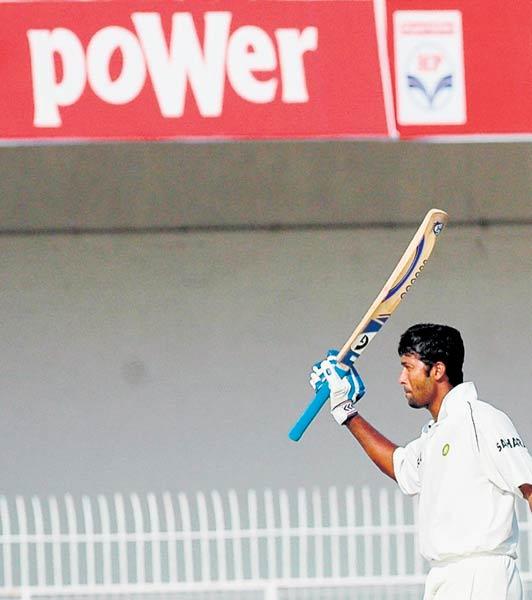 India's batsman Wasim Jaffer racing his bat after scoring 100 during the fifth day of the first Test match between India and England at the Vidharba Cricket Association Stadium in Nagpur