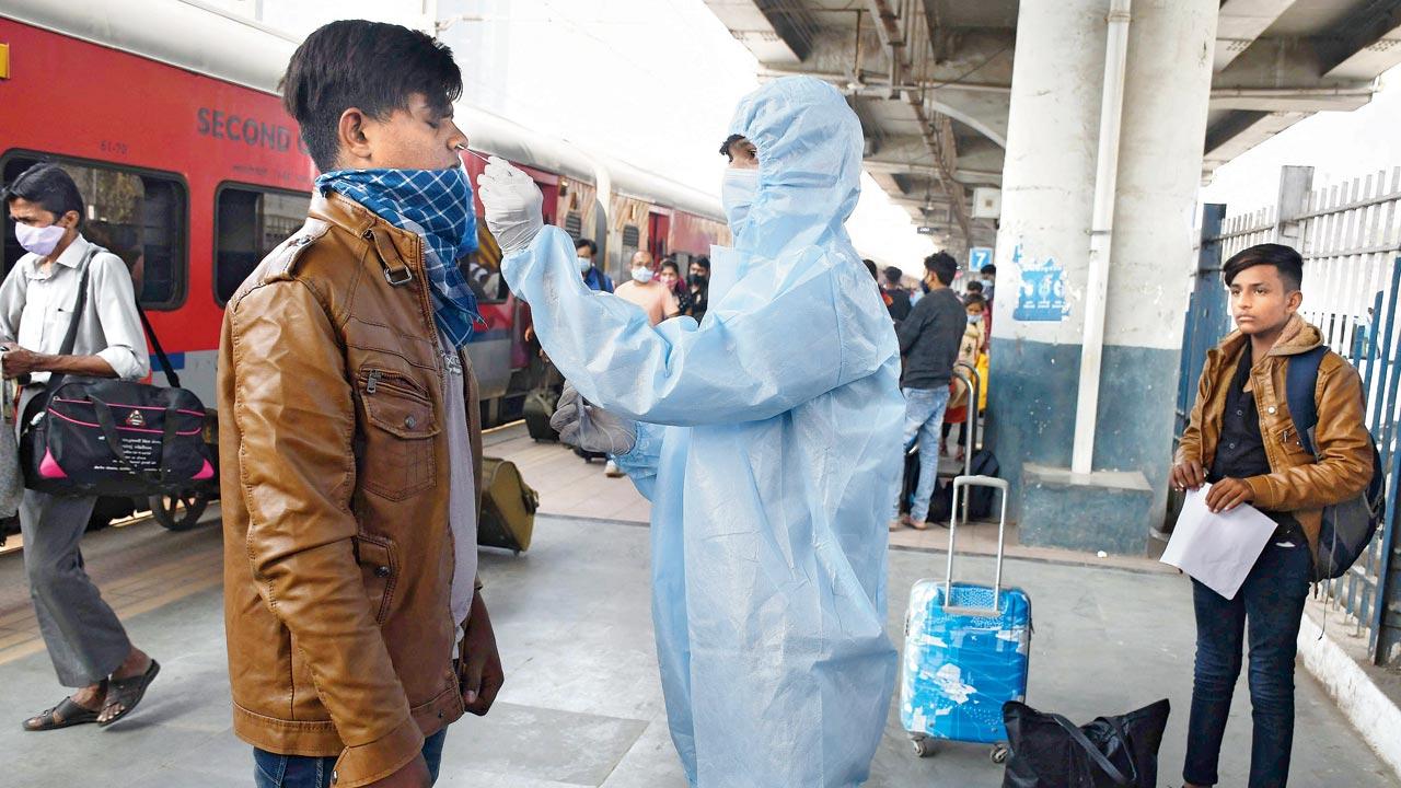 A BMC worker collects a sample from a man at Dadar on Wednesday. Pic/Ashish Raje