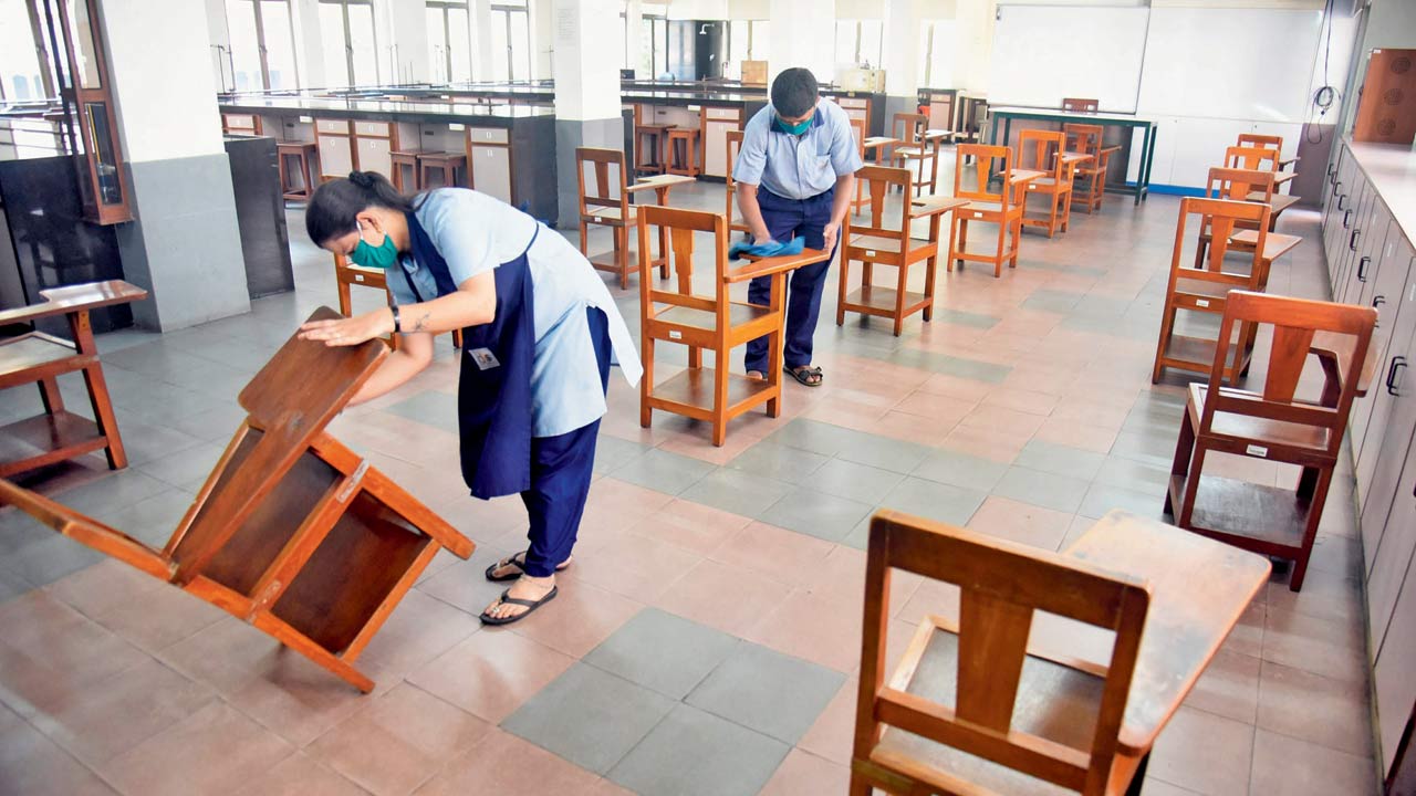 Staffers sanitise a classroom at The Cathedral And John Connon School, Fort. File pic