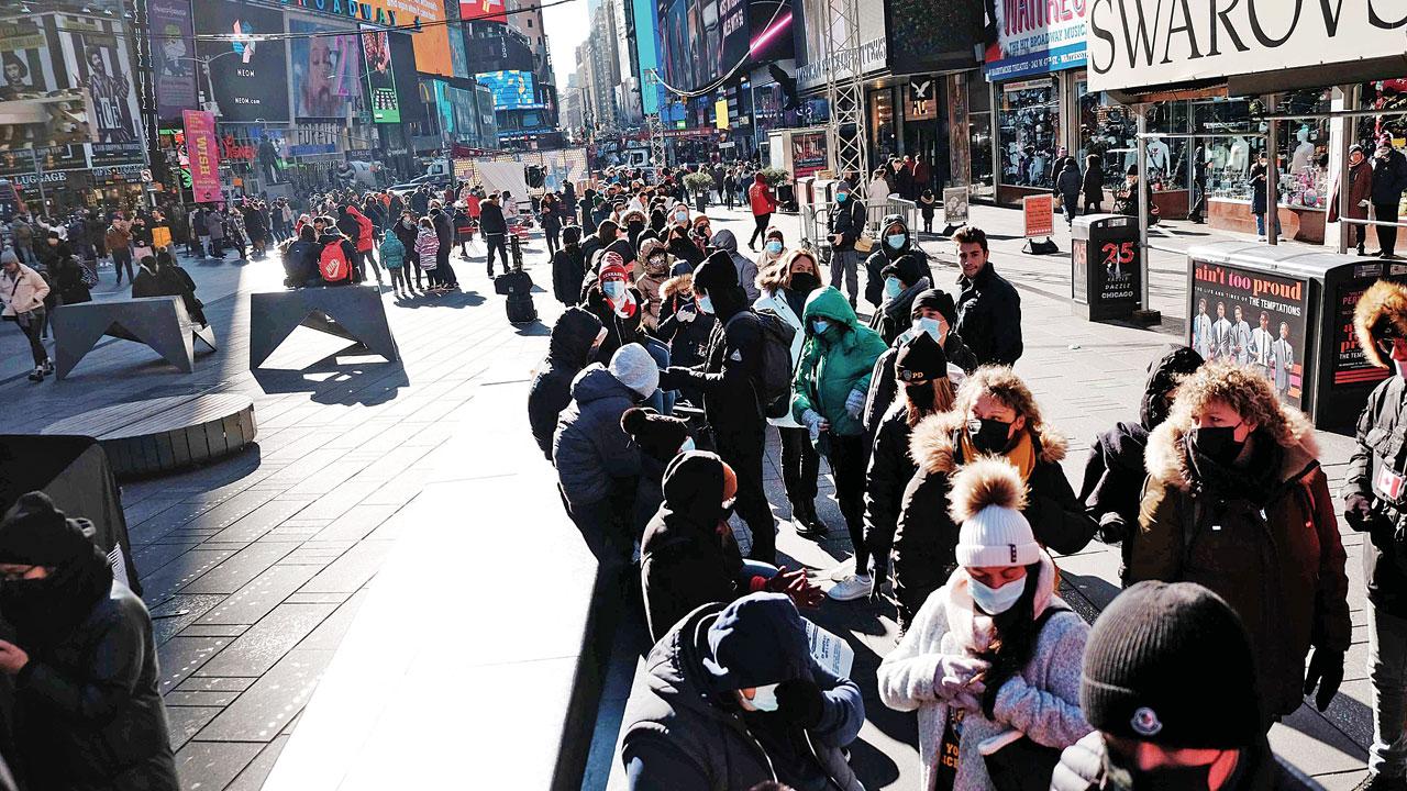 People queue up to get tested at Times Square in New York on Monday. Pic/AFP