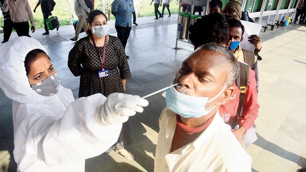 A health worker collects a sample at LTT, Kurla, on Thursday. Pic/Sameer Markande