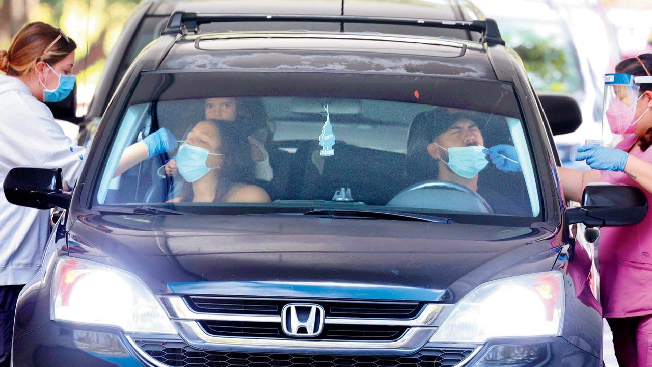 An Orange County family gets tested on the first day of the new COVID-19 drive-thru testing site hosted by Orange County Health Services in Orlando, Florida on Monday. Pic/AP