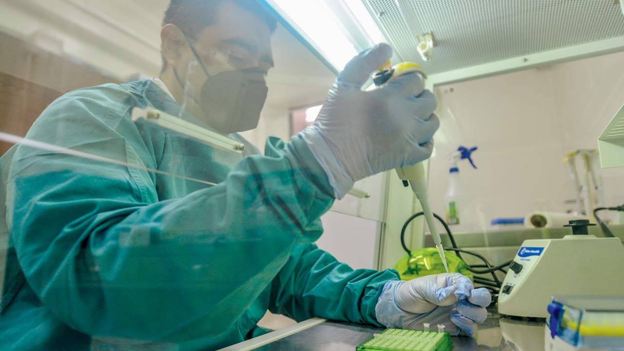 Dr Carlos Ortega of the University of El Salvador Virology Centre works on Coronavirus genome sequencing. More than 1.2 million Coronavirus genome sequences from 172 countries have been shared on GISAID,  a global science initiative that provides open-access to genomic data of viruses. Pic/Getty Images