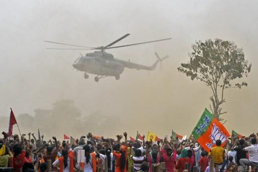 5) Modi, Amit Shah election rallies in West Bengal 
Amid the alarming rise in Covid-19 cases in April 2021, PM Narendra Modi and Home Minister Amit Shah held their unmasked election rallies in West Bengal. Thousands of people were part of the rallies when India reported a record 2.34 lakh new Covid-19 cases on the same day. PM Modi even said he was “elated” to see such a huge gathering.
Photo caption: Supporters of BJP wave towards a helicopter carrying PM Modi upon his arrival at a public rally during the fourth phase of the West Bengal's state legislative assembly elections, at Kawakhali on April 10, 2021.Pic/AFP