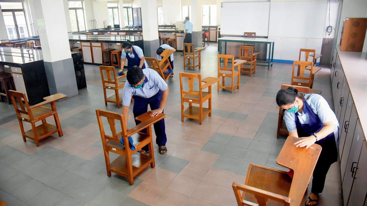 Staffers clean a classroom at Cathedral and John Connon School at Azad Maidan. File pic