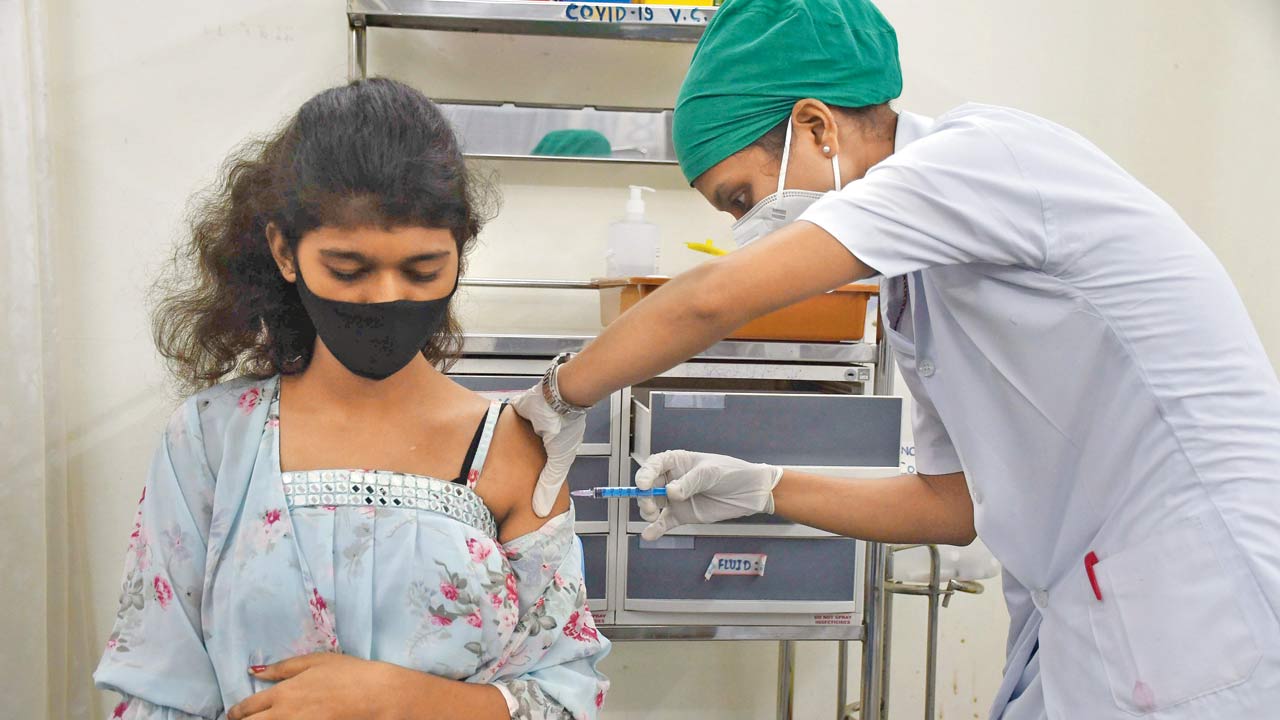 A woman gets a COVID vaccine shot at Nair hospital. File pic