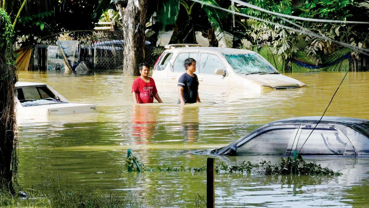 Rescue workers in Malaysia free people trapped by flooding