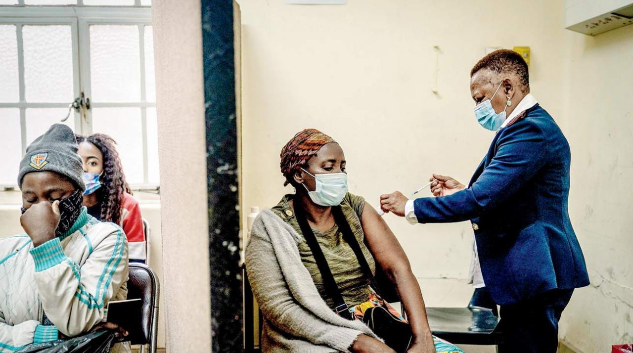 South Africa prepares itself as Omicron starts a fourth wave of Covid-19 A woman is vaccinated against COVID-19 at the Hillbrow Clinic in Johannesburg, South Africa, on Monday. Pic/AP