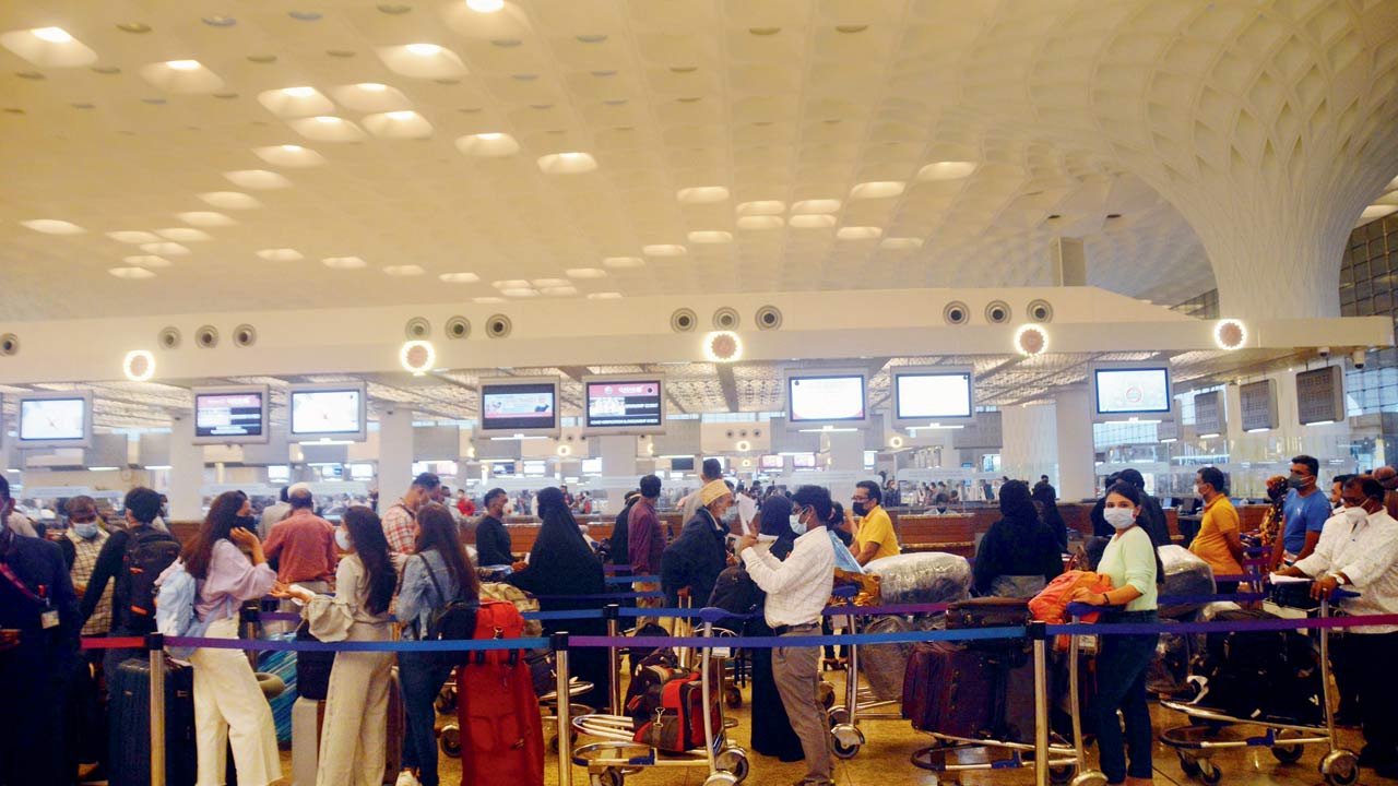 People queue up at the check-in counter, at Mumbai international airport. File pic/Satej Shinde