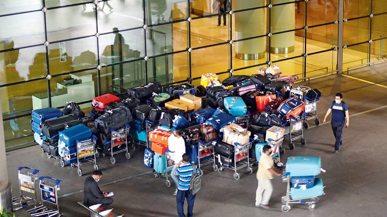 People wait for passengers at the arrival section of the Mumbai international airport on November 30. File pic