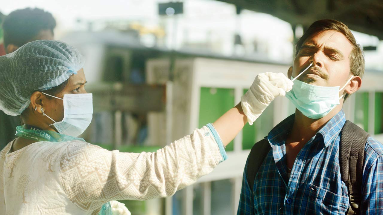 Swab sample of a passenger being collected at LTT, on Sunday. Pic/Atul Kamble