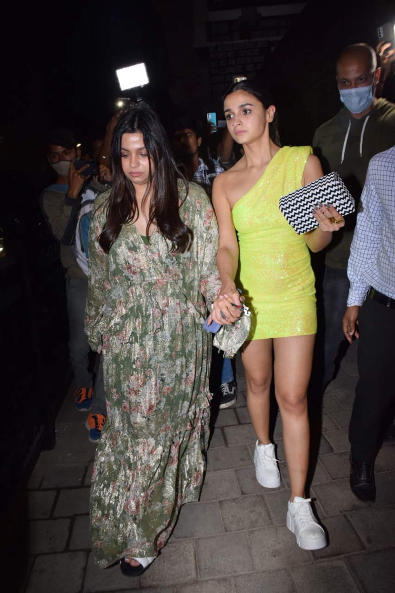 Shaheen Bhatt and Alia Bhatt walked at the dinner party together. Alia was seen wearing a pretty yellow glitter outfit, which she paired with white sneakers. Earlier, for her shoot at the Film City, was seen wearing pretty white stilettos which she changed with something comfier for the dinner party.