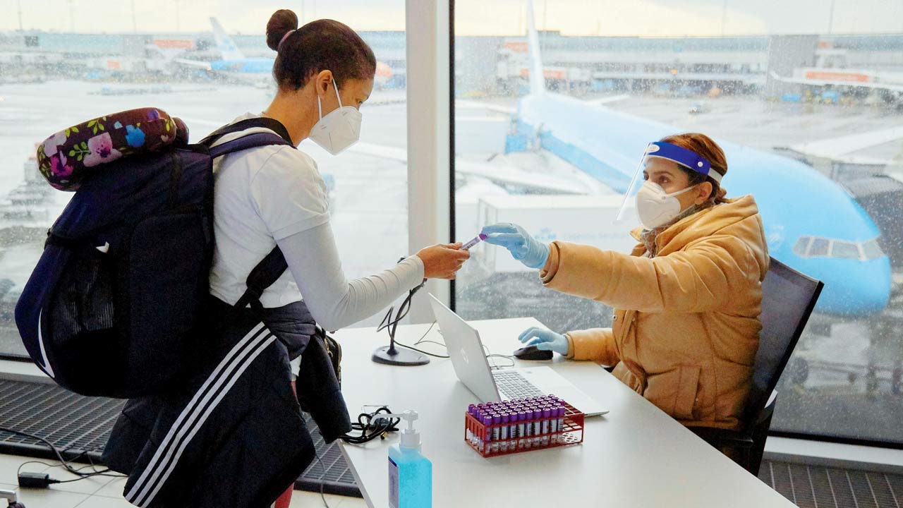 A passenger from a flight from South Africa is tested for the Coronavirus at Amsterdam Schiphol airport on December 2. The Netherlands and other nations worldwide temporarily banned travellers from South Africa after the emergence of the Omicron variant. Interestingly, it has emerged that Netherlands could have had Omicron cases a week before SA identified them. Pic/Getty Images