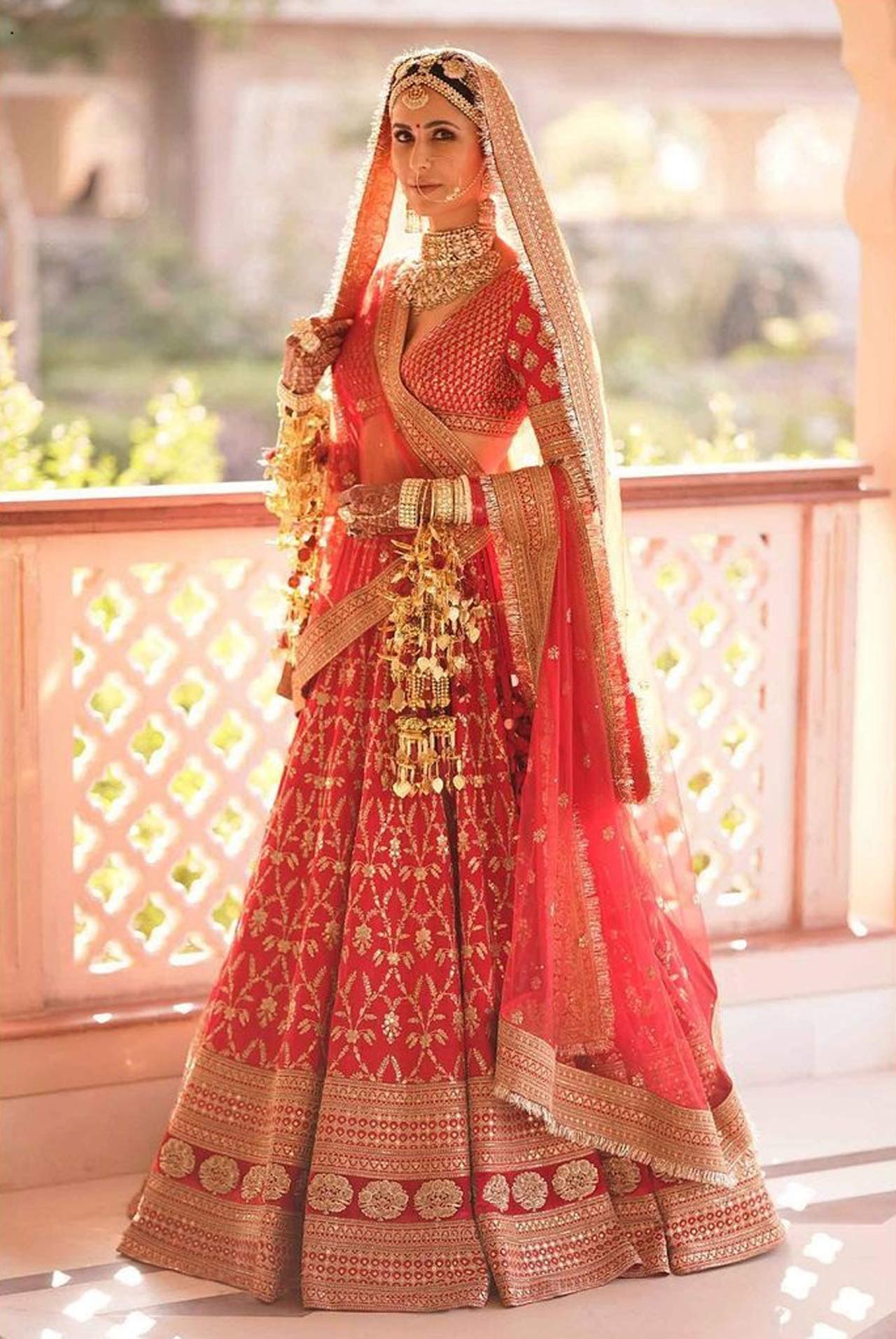 In homage to Vicky Kaushal's Punjabi roots, Katrina's veil was custom-trimmed with handmade kiran. The lehenga was paired with bespoke bridal jewellery of uncut diamonds in 22k gold with hand-strung pearls from Sabyasachi Heritage Jewellery.