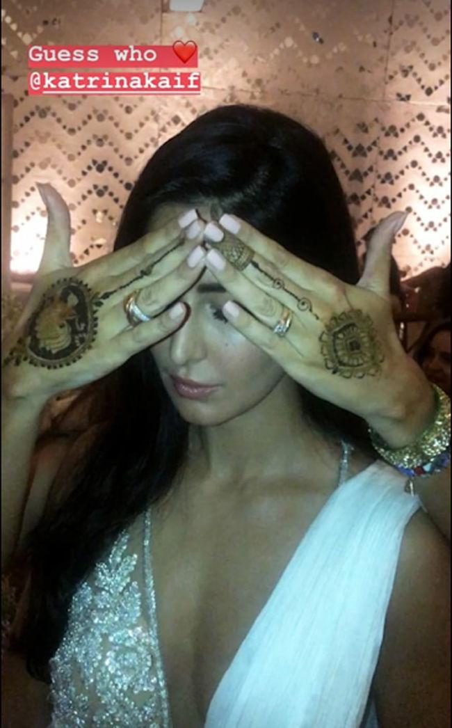 Katrina Kaif plays peek-a-boo while posing for a picture during the sangeet ceremony of Sonam Kapoor and Anand Ahuja.