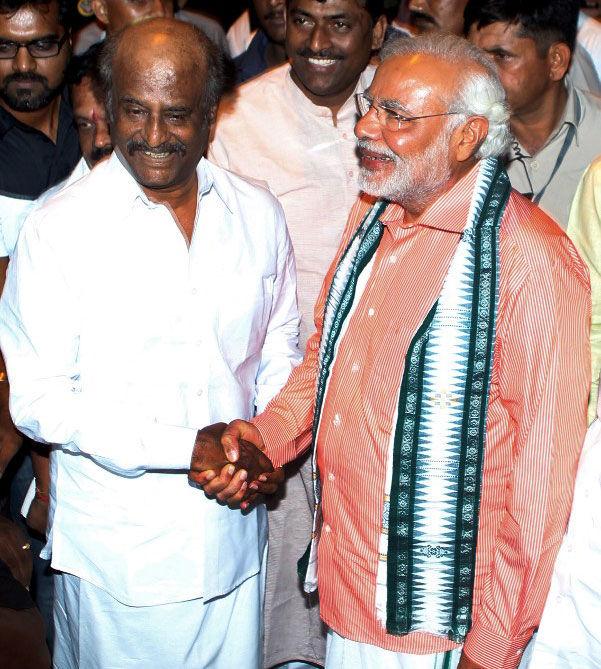 Narendra Modi, clad in traditional south Indian Dhoti attire, shakes hands with superstar Rajinikanth during a visit to the actor's residence in Chennai on April 13, 2014. Pic/AFP