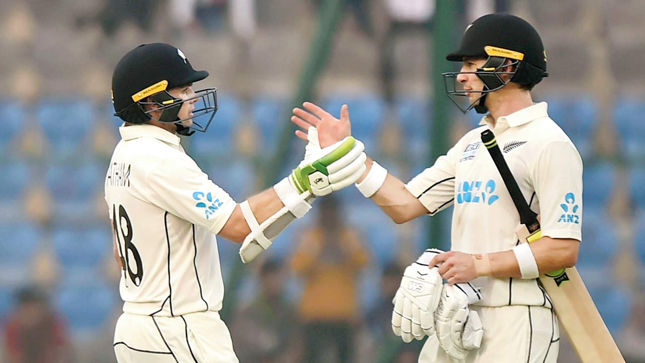 New Zealand’s Tom Latham (left) celebrates his half-century with Will Young on Day Two of the first Test at Kanpur last week. Pic/PTI
