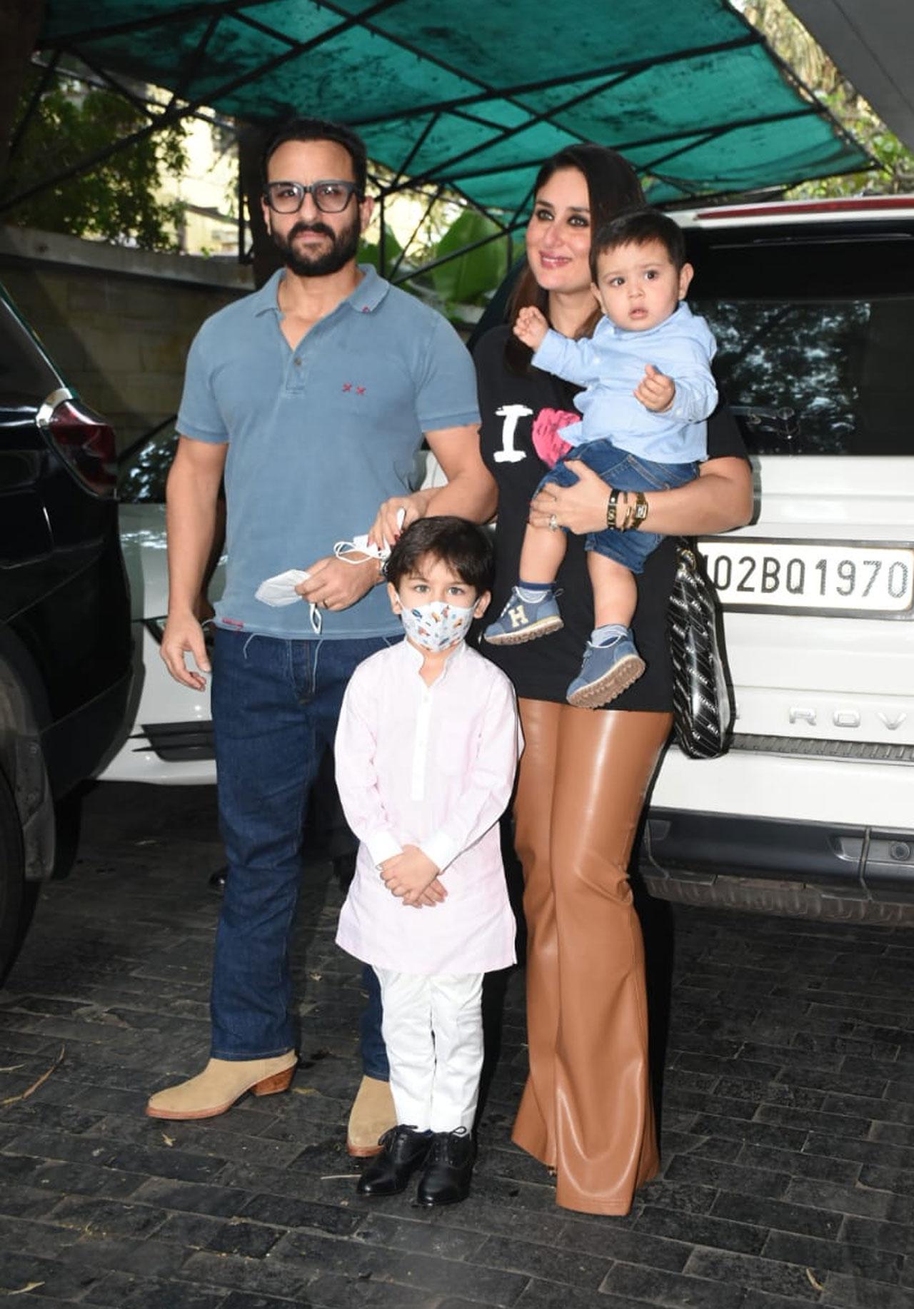 Saif Ali Khan and baby Jehangir Ali Khan twinned in blue as they were papped by the media for 2021 Christmas celebrations. Kareena Kapoor Khan donned a unique outfit of a black tee and shiny brown pants whereas Taimur Ali Khan aced his traditional outfit for the day.