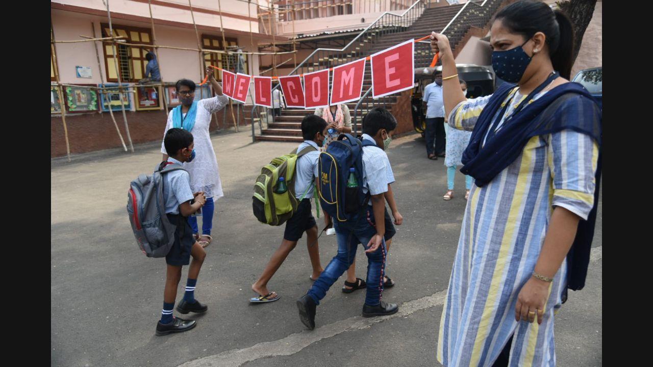 Many children wearing uniforms and carrying schools bags appeared happy and excited while entering the premises of various civic-run institutions after a long gap. Pic/Nimesh Dave