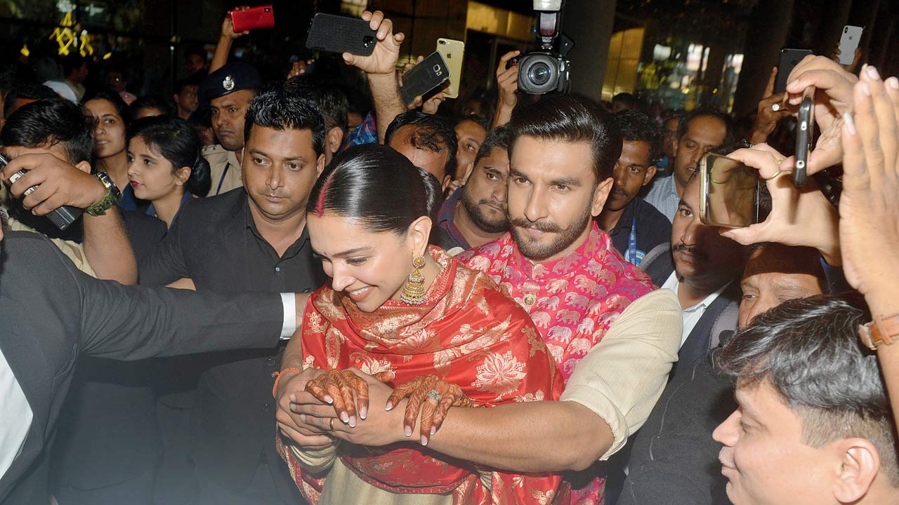 Carefully coordinated in red and ivory silk, Padukone and Ranveer Singh arrived in Mumbai from their Italian destination wedding indulging in the antics that photographers live to capture