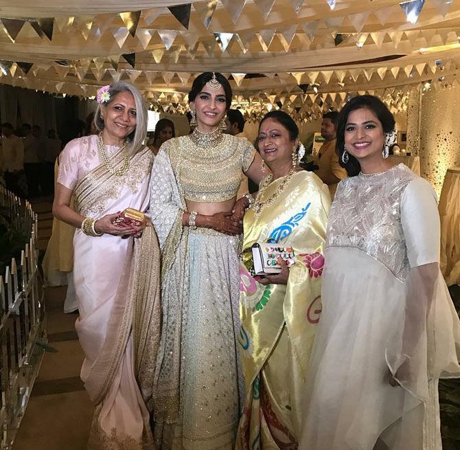 Bride-to-be Sonam Kapoor poses with guests at her sangeet ceremony.