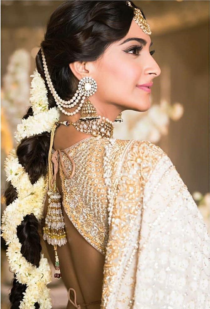 For her grand sangeet ceremony, Sonam Kapoor wore a traditional dress that featured a heavily-embroidered gold blouse and ivory-gold lehenga.