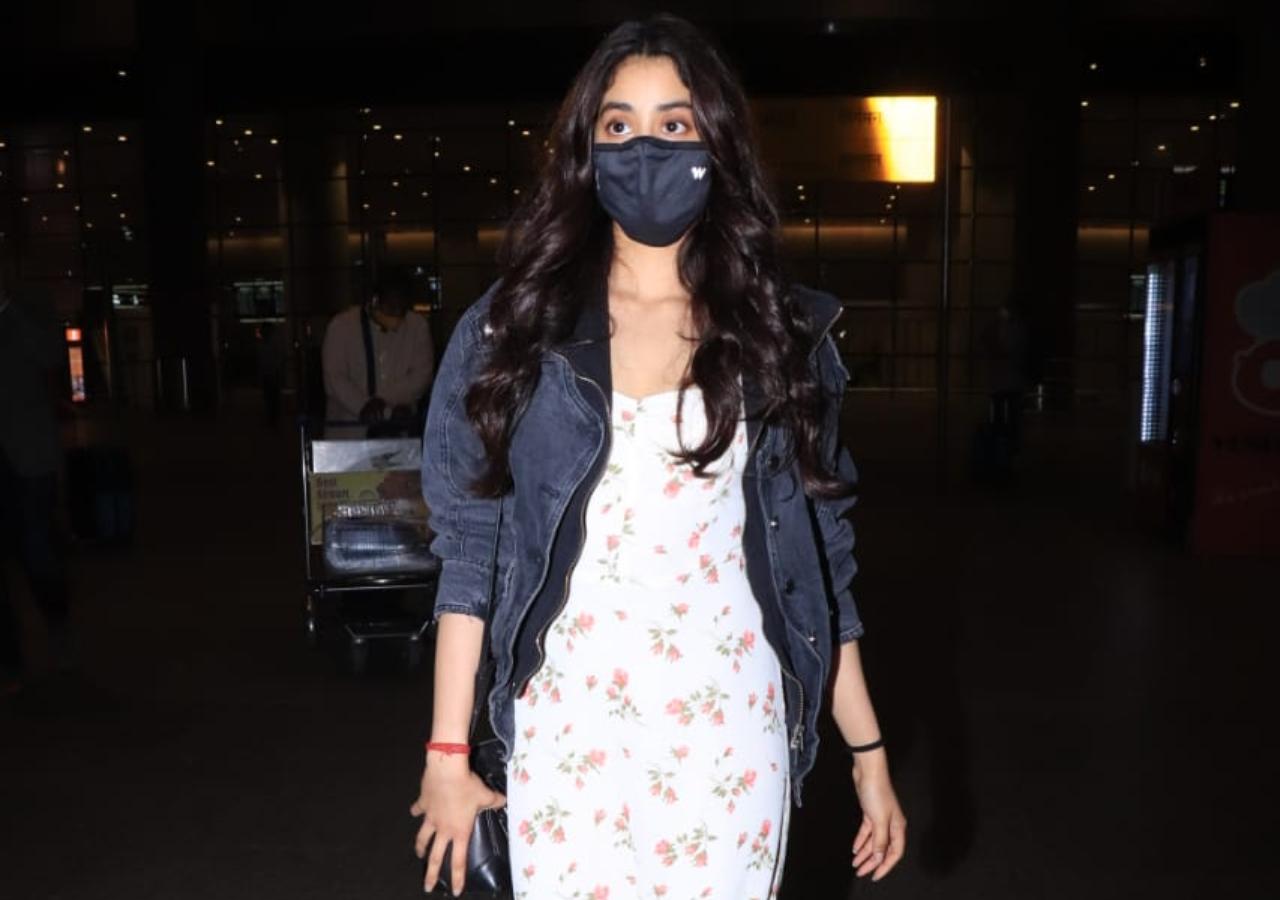 Janhvi Kapoor looked gorgeous in her white printed dress and denim jacket as she was snapped at the Mumbai Airport. She wore a blue mask to prevent the spread of COVID-19. (All pictures: Yogen Shah).