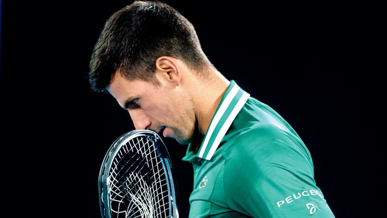 Novak Djokovic with his smashed racquet during the quarter-final against Alexander Zverev. Pics/AFP