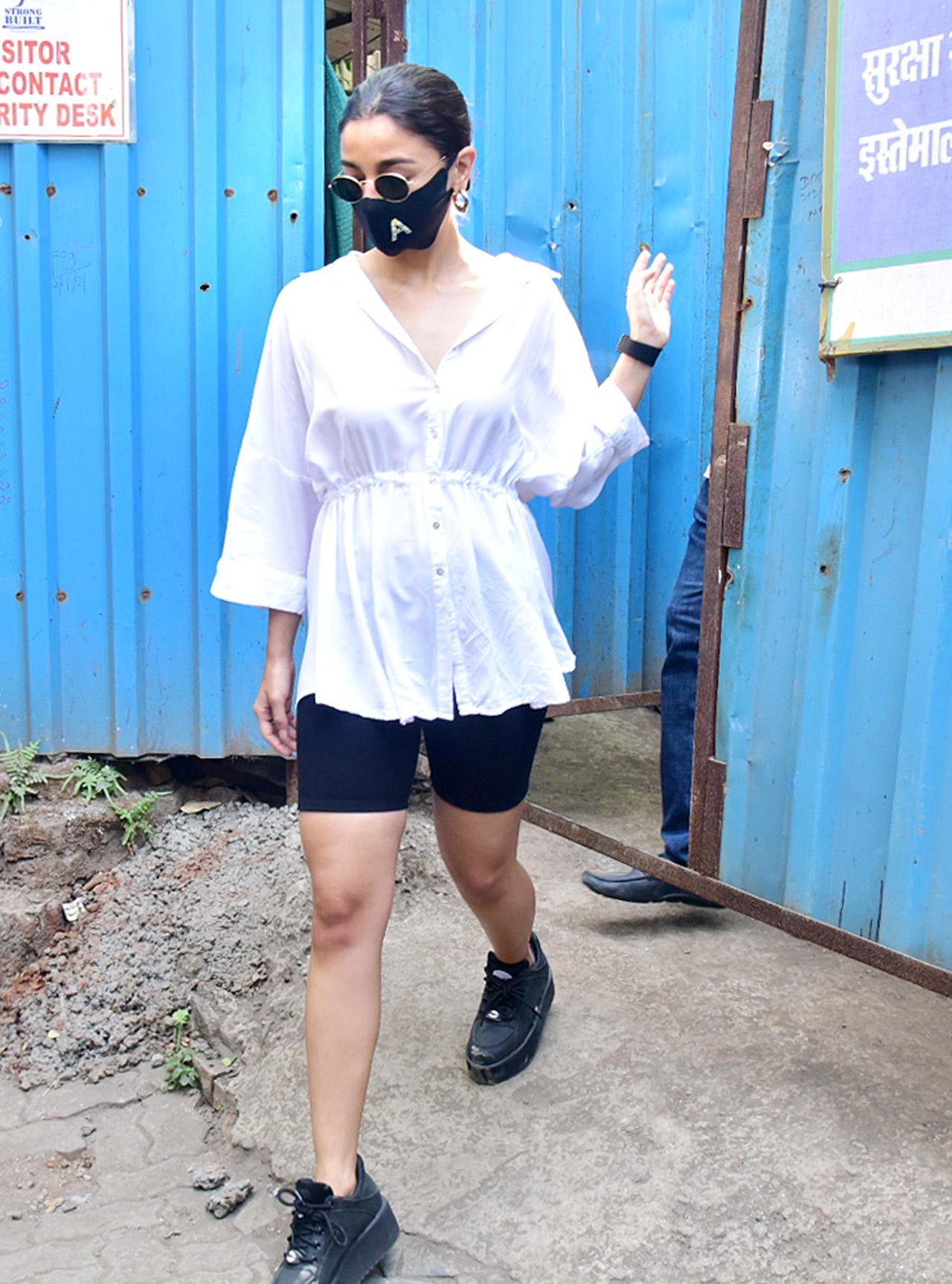 Alia Bhatt opted for a white shirt, paired with black cycling shorts. She completed her look by sporting black sunglasses and black boots.