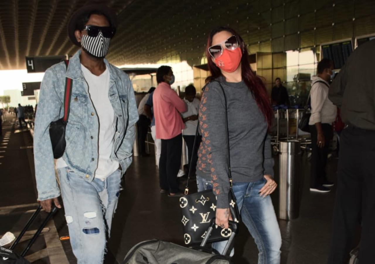 Remo D'Souza was snapped with his wife Lizelle D'Souza at the Mumbai Airport. Seems the husband-wife duo are off to a much-needed vacation. (All pictures: Yogen Shah).